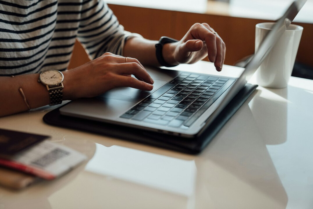 author typing on laptop